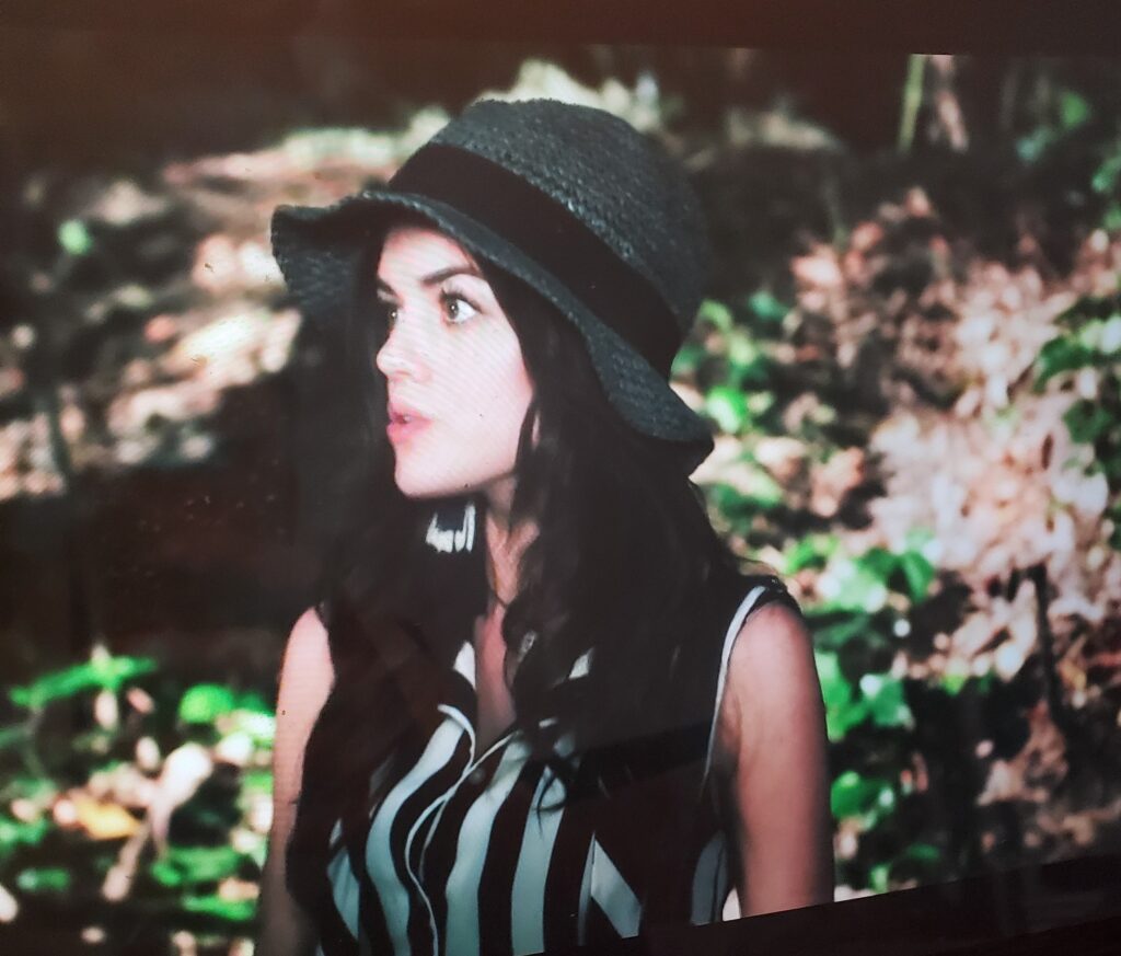 Close-up of Aria in her woods outfit, showing the green hat more prominently