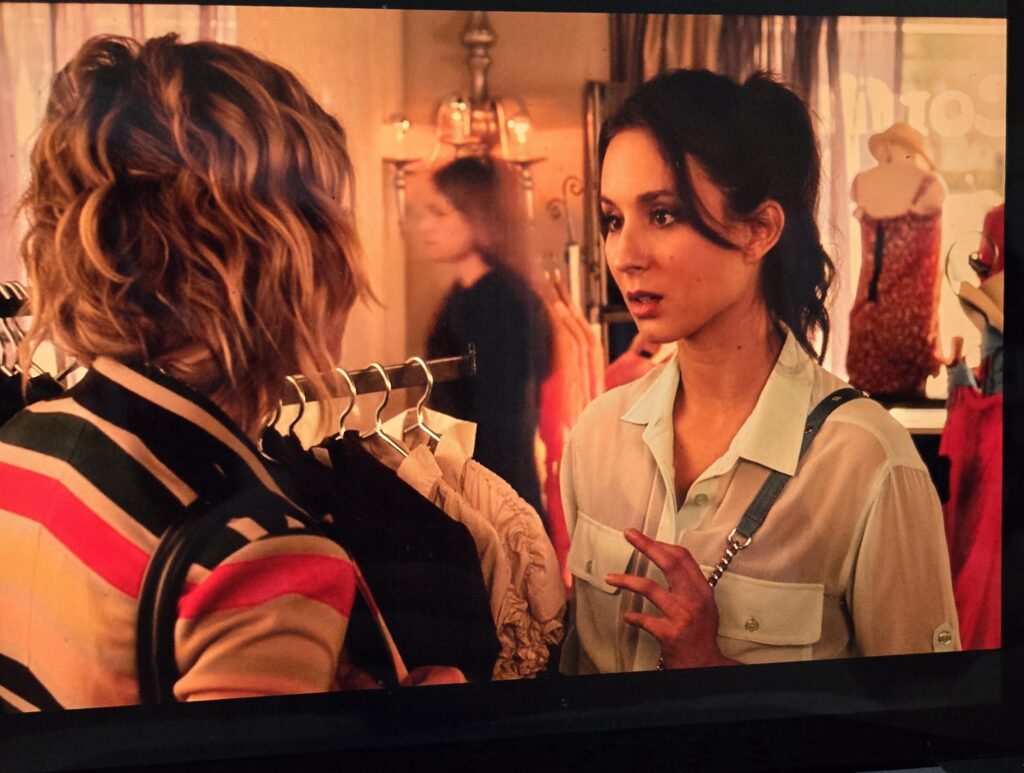 Spencer and Hanna talking in the boutique. Spencer is wearing a sheer button-down