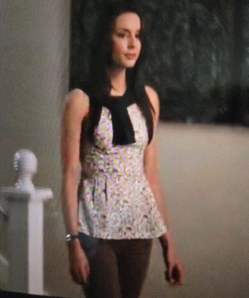 Full body picture of Spencer in a peplum tank top and ugly pants