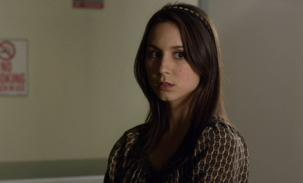 Spencer wearing a shirt with a repeating pattern of tiny brown owls, and a headband that is in the same brown and cream color scheme