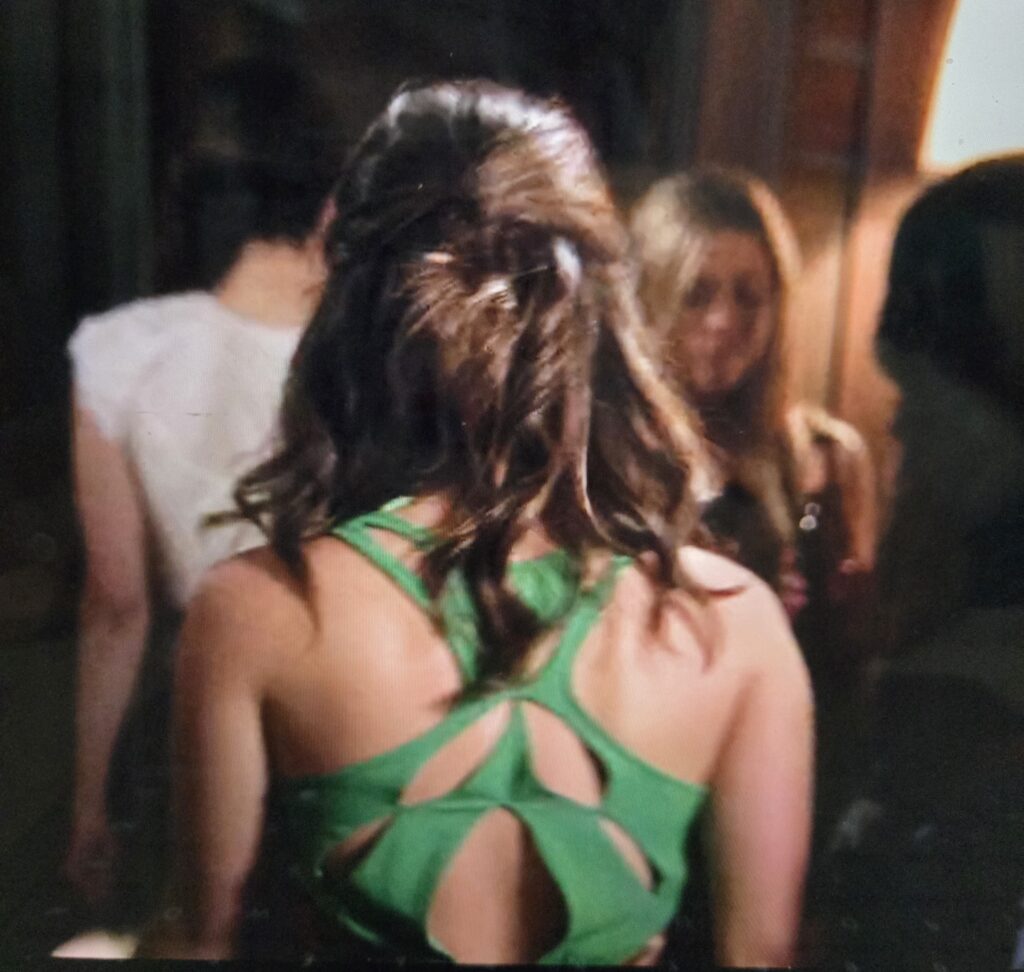 The back of Aria’s bright green party dress with interesting cut outs