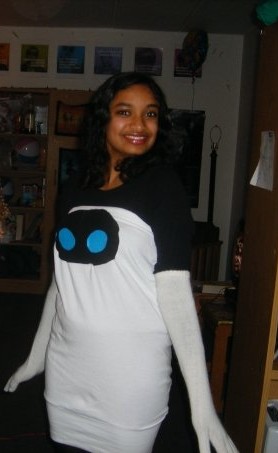 Deepa's Halloween costume circa 2009 as Eve from WALL-E; Deepa is wearing a black long-sleeved top with a white tube top dress over it that makes up Eve's body, with Eve's eyes pinned onto the dress at the chest and white gloves to make Eve's arms